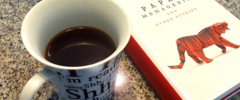 Image of a cup of black coffee alongside Ken Liu's collection The Paper Menagerie and Other Stories.